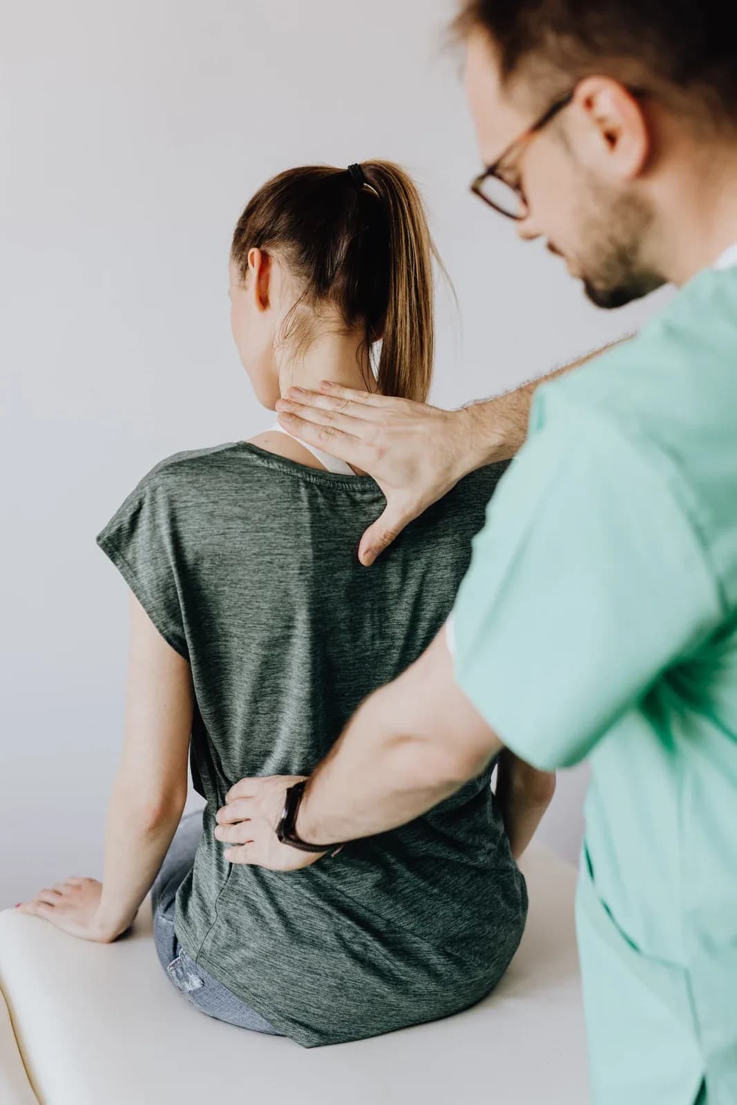 Physical therapist helping patient with exercises at home